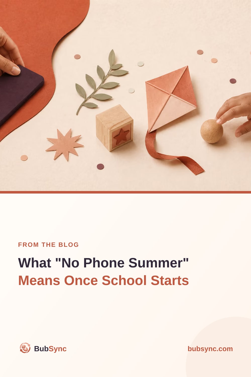An adult sets a phone aside while a child reaches for a wooden ball, paper kite and block